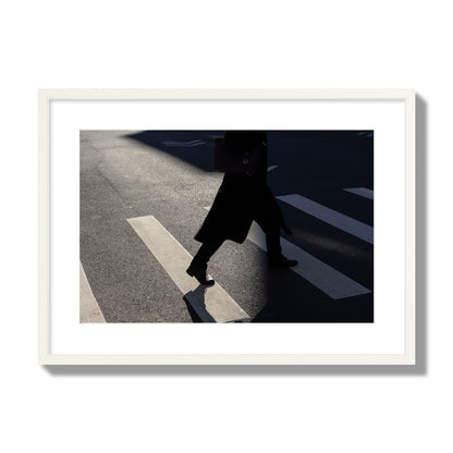 Fine art street photograph of a woman walking through a crosswalk in Soho New York, archival pigment print, large size, white frame