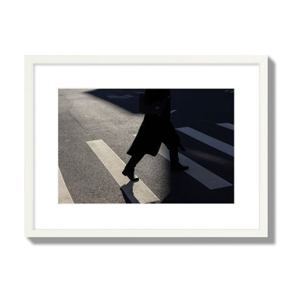 Fine art street photograph of a woman walking through a crosswalk in Soho New York, archival pigment print, medium size, white frame