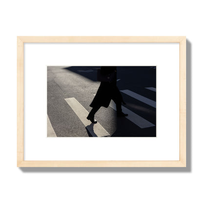 Fine art street photograph of a woman walking through a crosswalk in Soho New York, archival pigment print, small size, natural wood frame