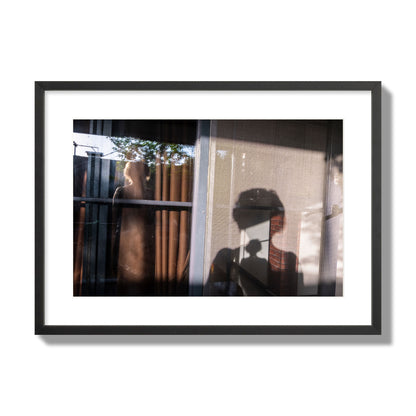 Fine art photograph of a person's silhouette against a window with curtains, archival pigment print, large size, black frame.