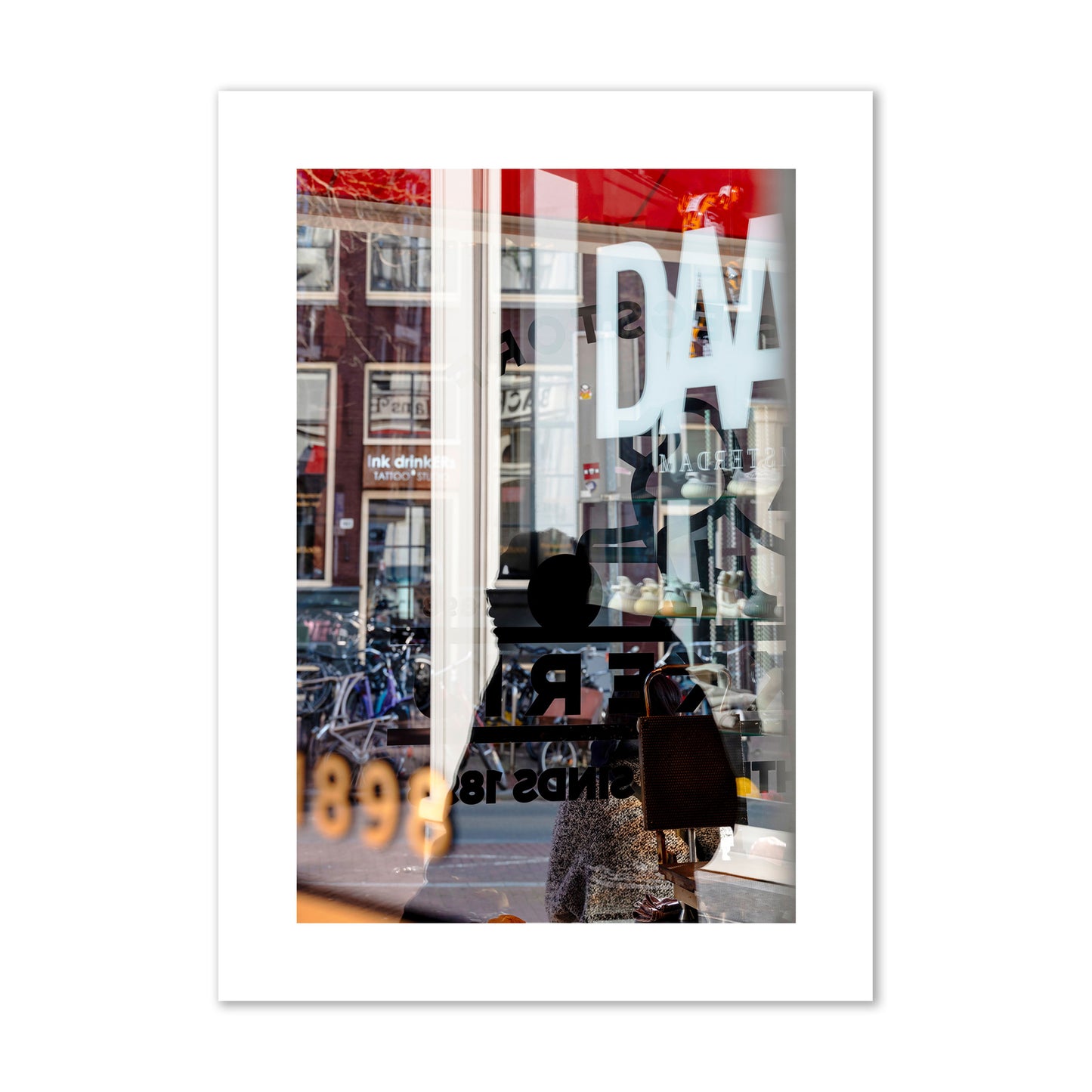 Fine art street photograph of a busy Amsterdam street scene with reflections, silhouettes, shoppers, and store signs. Archival pigment print, giant size, unframed.