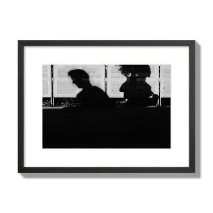 Fine art black and white street photography capturing the silhouettes of two individuals against a wall in Athens Greece, archival pigment print, medium size, black frame