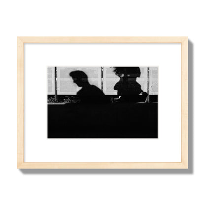 Fine art black and white street photography capturing the silhouettes of two individuals against a wall in Athens Greece, archival pigment print, small size, natural wood frame