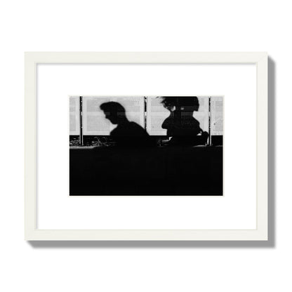 Fine art black and white street photography capturing the silhouettes of two individuals against a wall in Athens Greece, archival pigment print, small size, white frame