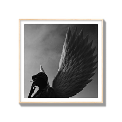 Fine art photography of a woman smoking in front of a winged statue, archival pigment print, gallery size, natural wood frame.