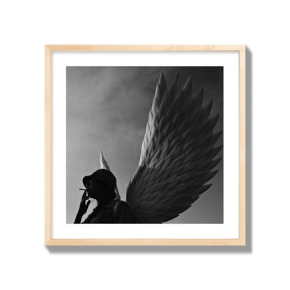 Fine art photography of a woman smoking in front of a winged statue, archival pigment print, giant size, natural wood frame.