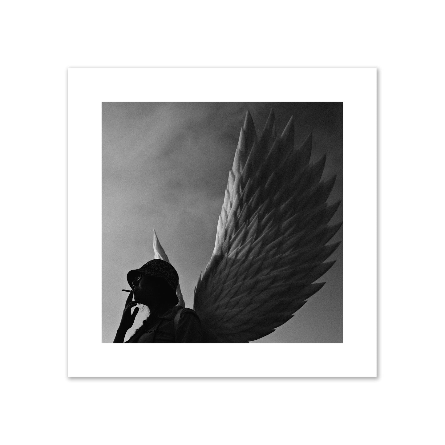 Fine art photography of a woman smoking in front of a winged statue, archival pigment print, giant size, print.