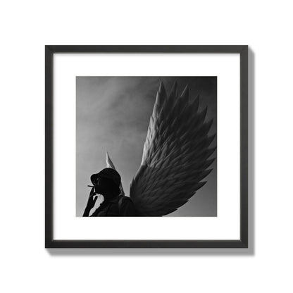 Fine art photography of a woman smoking in front of a winged statue, archival pigment print, large size, black frame.