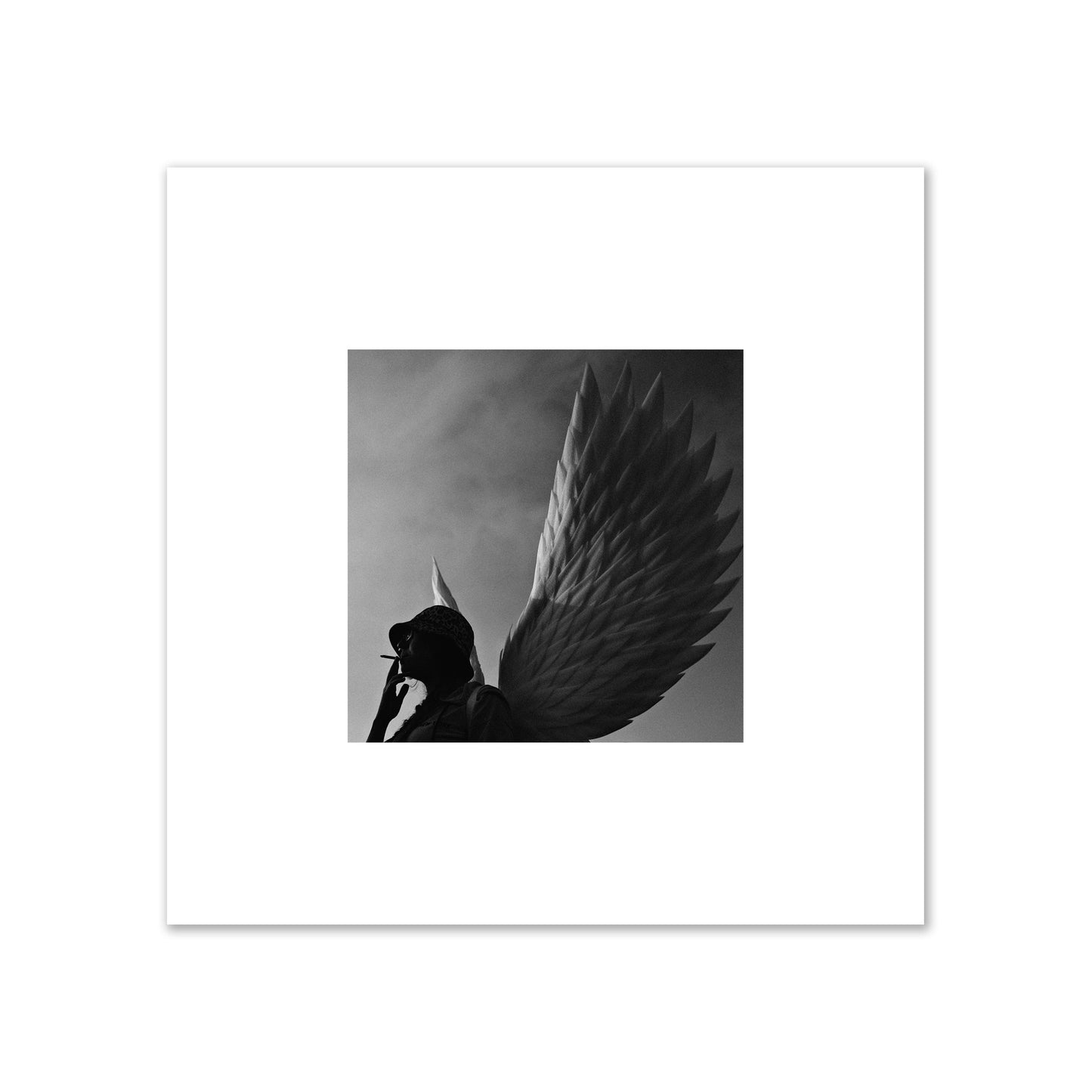 Fine art photography of a woman smoking in front of a winged statue, archival pigment print, small size, print.